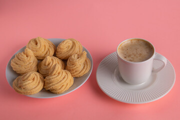 photo cakes next to a cup of coffee on a saucer