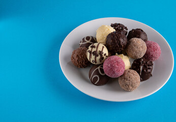 photo many chocolates on a white plate