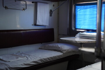 Almaty, Kazakhstan - 05.20.2022 - Seats for passengers with mattresses and bedding in the carriage.