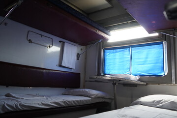 Fototapeta premium Almaty, Kazakhstan - 05.20.2022 - Seats for passengers with mattresses and bedding in the carriage.