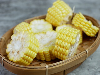 chopped raw corn on a bamboo plate