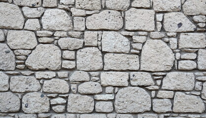 Antique Wall, finished with rubble stone. Grunge Background. Black and white Photo
