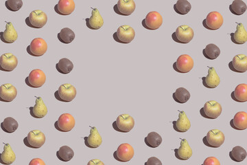 Creative pattern made with fresh grapefruits, kiwis, apples and pears on pastel beige background. Summer fruit background