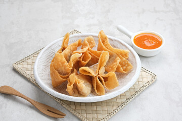 Pangsit Goreng (Chicken Fried Dumpling), Indonesian Traditional Food. Served with sauce
