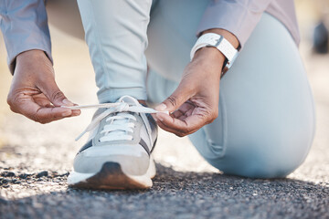 Woman, hands and shoelace for street runner, outdoor workout and fitness in summer sunshine in morning. Running adventure, shoes and tie lace for safety, speed and balance in road exercise for health