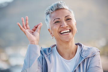 OK hand, fitness senior woman and nature portrait for exercise, wellness or workout success, trust and healthy elderly promotion. Yes sign, happy and retirement woman for sports or wellness journey