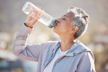 Fitness, health and senior woman drinking water for hydration on outdoor cardio run, exercise or...