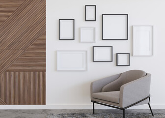 Various empty picture frames on white wall in modern room. Mock up interior in contemporary style. Free, copy space for pictures, posters, artworks or photos. Group of frames. 3D render.