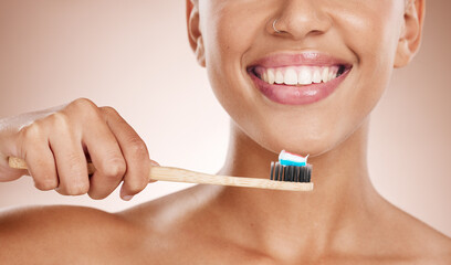 Woman, cosmetics and brushing teeth for dental hygiene, smile and clean mouth on studio background....