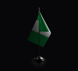 Small national flag of the Nigeria on a black background