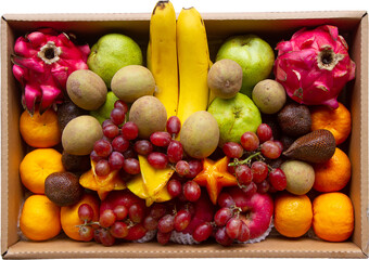 Tropical fruit in a box cut out on isolated background