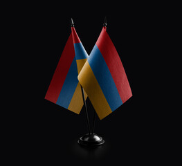 Small national flags of the Armenia on a black background