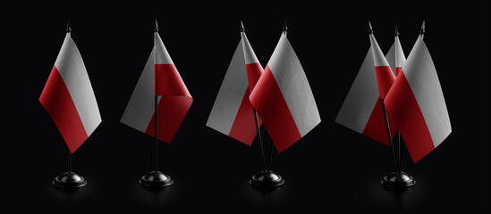 Small national flags of the Poland on a black background