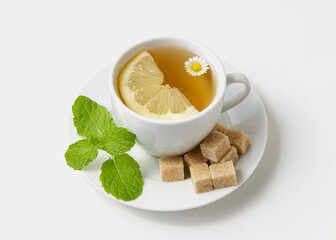 Chamomile tea with mint and lemon on white background.