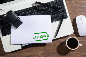 Document with approved stamp and business objects.