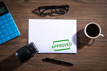 Document with approved stamp and business objects.