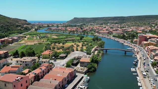 Temo River flows through Bosa to the sea at Sardinia, Italy - 4k Aerial