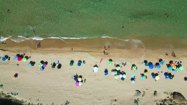Parasols at San Nicolo Beach in Buggerru, Sardinia, Italy - 4k Aerial Birdseye