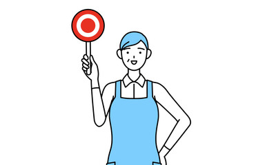 正解を示すマルの棒を持つエプロンを着たシニア女性