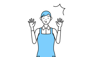 驚いて手を上げるエプロンを着たシニア女性