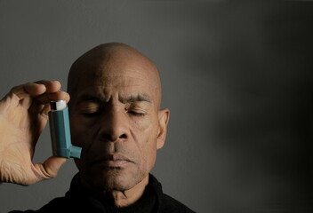 man with flu and inhaler respiratory puff on grey background with people stock photo   