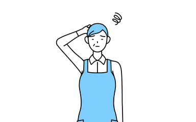 困って頭をかくエプロンを着たシニア女性