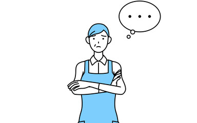 腕を組んで考えるエプロンを着たシニア女性