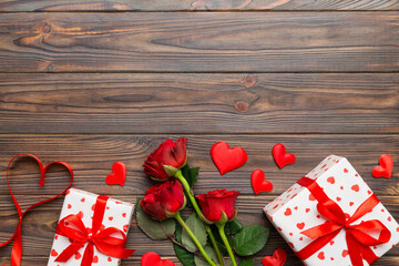 Valentine's day composition with rose flower, red heart and gift boxes on table. mother day and birthday greeting, copy space, top view