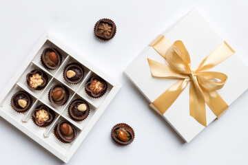 White box with chocolates candies and golden tape. top view with copy space