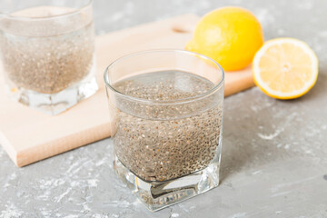 Healthy breakfast or morning with chia seeds and lemon on table background, vegetarian food, diet and health concept. Chia pudding with lemon