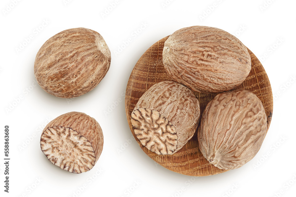 Wall mural nutmeg in wooden bowl isolated on white background with full depth of field. Top view. Flat lay