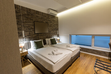Interior of a hotel bedroom with master bed