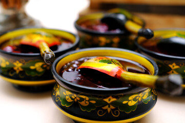 Russian folk Khokhloma dishes with jam. Top view