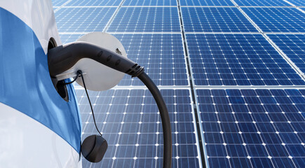 Close up of electric car with a connected charging cable on the background of solar panels	