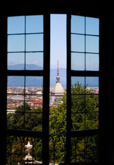 Turin - Italy - Urban skyline with Mole Antonelliana building, blue sky and Alps mountains.