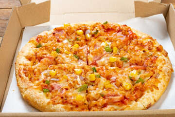 angle view fresh pizza with bacon toppings in a box