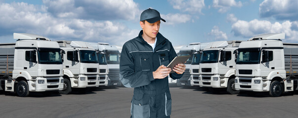 Manager with a digital tablet next to trucks. Fleet management	