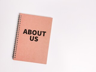 Concept of about us. Top view notebook cover written about us.