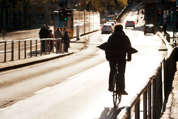 Silhouette of bicyclist in rush on a city street