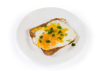 Open sandwich with fried egg on a white dish