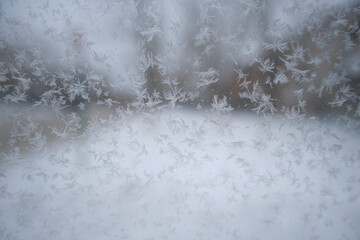 Abstract winter background, snowflakes on glass.