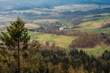 Obraz premium A romantic view of the beautiful valleys and arable fields from the Stołowe Mountains, a distant view to the horizon, a large space that gives a sense of freedom and independence. Polish Karkonosze, b