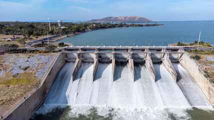 An aerial view over the Pasak Jolasid dam, Lopburi Province, Thailand. Tracking the movement of the floodgates that are releasing water into rural canals in enormous amounts of water.