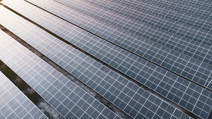 Obraz premium Fly over Solar cells on the roof of a large industrial factory. Solar roofs are generating renewable energy for the industry. The goal is to reduce the cost of electricity.