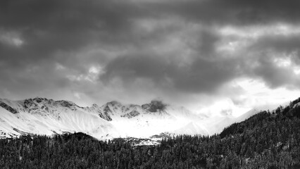 Mountain landscape. Cold mountain. Alps at sunset. Towering blue cloud.Glacier in the mountains.Panorama on top of a snowy mountain near Saint Jean de Maurienne. Saint Jean de Maurienne in the French 