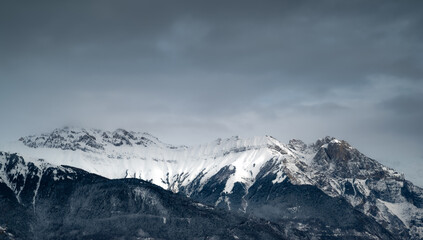 Mountain landscape. Cold mountain. Alps at sunset. Towering blue cloud.Glacier in the mountains.Panorama on top of a snowy mountain near Saint Jean de Maurienne. Saint Jean de Maurienne in the French 