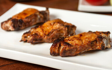 delicious grilled pork steaks on a white plate