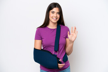 Young Brazilian woman with broken arm and wearing a sling isolated on white background counting...