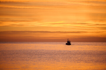 Boat heading out at sunrise