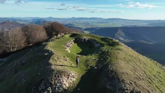 Hiker going up to the top of the mountain. Mount Trinidad de Erga, Navarra